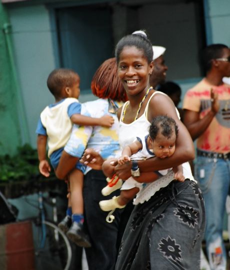 Mother in Santiago de Cuba, dancing Conga with her baby