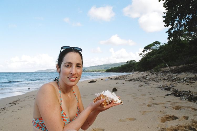 Noa holding sea-shells on the beach near Baracoa