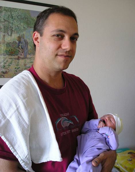 Yaron holding newborn Noga